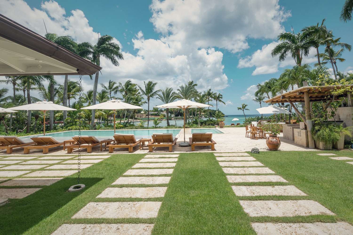 A terrace and pool at the water's edge