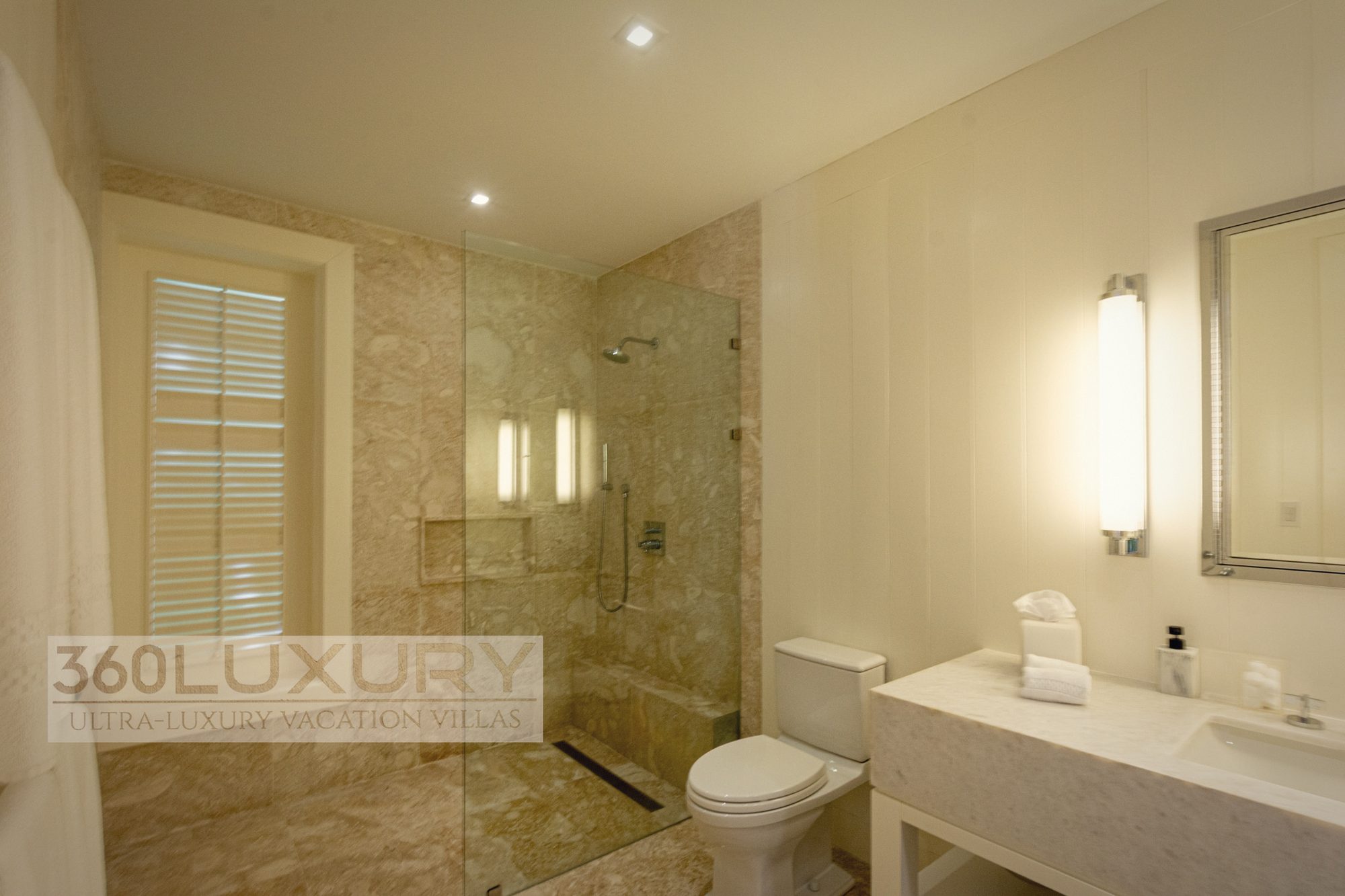 A shower room in coral stone, Villa Bellarive, Casa de Campo